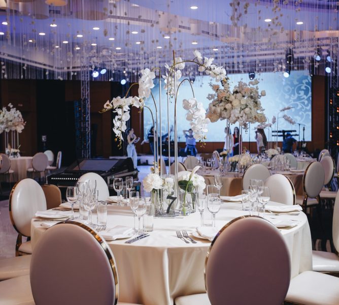 tableware Glasses, flower fork, knife served for dinner in restaurant with cozy interior